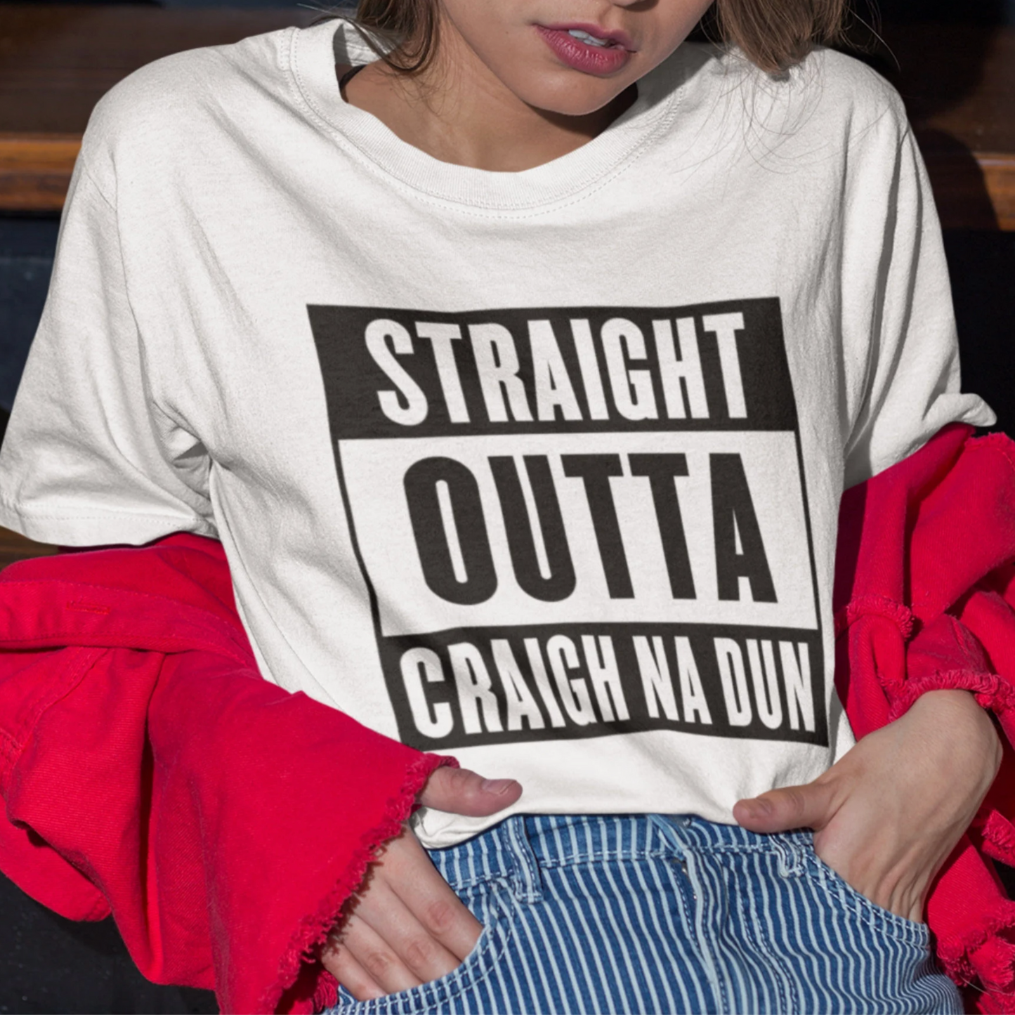 Person wearing a white sweatshirt with 'STRAIGHT OUTTA CRAIGH NA DUN' text.